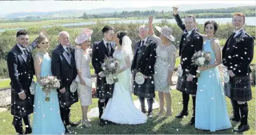  ??  ?? Kiss the bride The wedding party shower newlyweds Emma and Scott with confetti