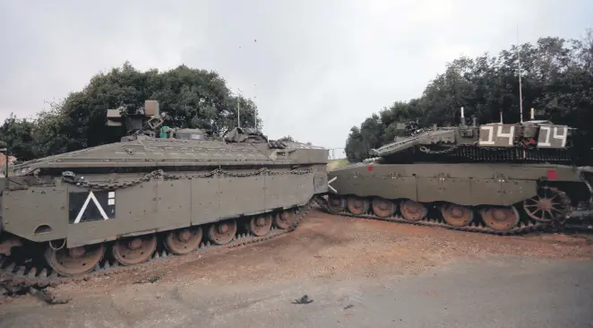  ??  ?? Israeli Merkava tanks parked near the border with Lebanon near the Israeli town of Zarit, Dec. 5.