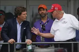  ?? SETH WENIG — THE ASSOCIATED PRESS FILE ?? Former President Donald Trump, right, talks with Donald Trump Jr., center, and Tucker Carlson at the 16th tee during the final round of the Bedminster Invitation­al LIV Golf tournament in Bedminster, N.J., on July 31.