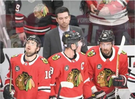  ?? DAVID BANKS/AP ?? New coach Jeremy Colliton (rear) brought some energy when he first arrived, Patrick Kane says, but his experiment­ing hasn’t led to wins.