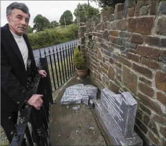  ?? Photo by John Reidy ?? Ben Brosnan beside the smashed Civil War Monument at Talbot’s Bridge in Knocknagos­hel following the most recent act of vandalism on the memorial stone.