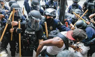  ?? PHOTOS BY XAVIER BURRELL / NEW YORK TIMES ?? Protesters take to the streets Wednesday in Louisville, Kentucky, after a grand jury decided not to bring charges against police officers who shot and killed Breonna Taylor during a botched nighttime raid on her apartment in March.