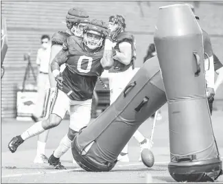  ?? Craven Whitlow - Submitted Photo ?? Razorback senior defensive lineman Markell Utsey (#0) from Little Rock, runs through a defensive drill at practice at the Willard & Pat Walker Pavilion Tuesday afternoon in Fayettevil­le.