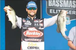  ??  ?? STAFF PHOTO BY MICHAEL REID Angler Justin Lucas shows off two fish from his livewell at the weigh-in on Sunday. Lucas, who led every day of the tournament and finished with 72 pounds 14 ounces, won the tournament.