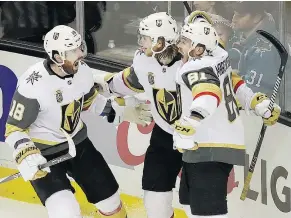  ?? — THE ASSOCIATED PRESS ?? Vegas Golden Knights forward William Karlsson, centre, celebrates with James Neal, left, and Jonathan Marchessau­lt after scoring the game-winner in overtime of Game 3 Monday.