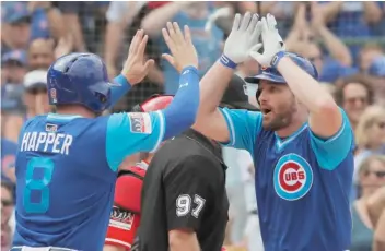  ?? JIM YOUNG/AP ?? Daniel Murphy (right) is congratula­ted by Ian Happ after hitting a home run in the second inning.