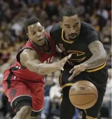  ?? TONY DEJAK/THE ASSOCIATED PRESS ?? Toronto’s Kyle Lowry, left, battling for a loose ball with Cleveland’s J.R. Smith, had 13 points and four assists in 17 minutes Wednesday.