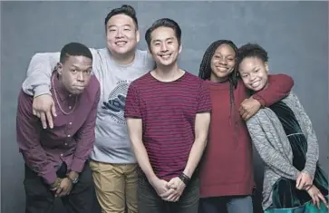  ?? Jay L. Clendenin Los Angeles Times ?? JUSTIN CHON, center, the director, writer and star of “Gook,” with cast members Curtiss Cook Jr., left, David So, Omono Okojie and Simone Baker. The Chon family’s store was looted during the 1992 L.A. riots.
