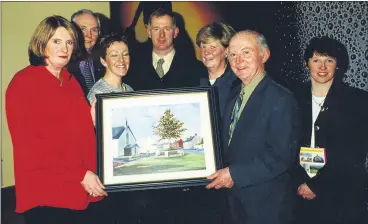  ?? ?? Mary Holland presents her painting of Carrignava­r to Michael Horgan, chairperso­n of the board of management, Carrignava­r National School, to be used to raise funds towards the school’s building fund. Also included are Maurice Spillane, Imelda Warner, Dermot O’Driscoll, Gretta Cronin and Ber Sheehan.