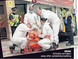  ?? ?? DEMO Activists are taken away after vandalisin­g building