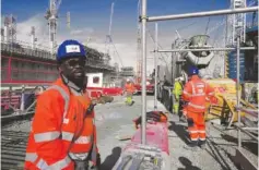  ?? AP PHOTO/KIN CHEUNG ?? Crew members work at the constructi­on site of a turbine at Hinkley Point C nuclear power station on Oct. 11 in Somerset, England.