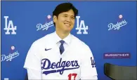  ?? (AP/Ashley Landis) ?? Los Angeles Dodgers’ Shohei Ohtani smiles Thursday during a news conference at Dodger Stadium in Los Angeles. Ohtani wouldn’t say whether the surgery he had on his elbow Sept. 19 was Tommy John surgery, saying “I’m not obviously an expert in the medical field, but it was a procedure.”