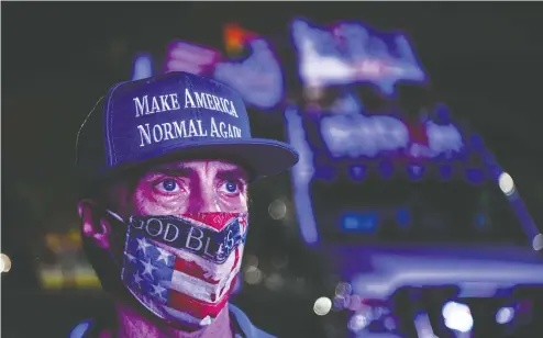  ?? CHANDAN KHANNA/AFP VIA GETTY IMAGES ?? Democratic Party supporter Andy Soberon looks on soberly at a watch party in Miami. Many polls had Joe Biden taking Florida, but Trump did.