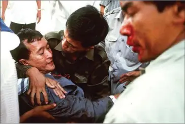  ?? DAVID VAN DER VEEN/AFP ?? Sam Rainsy, then-president of the Khmer National Party, is carried away after the grenade attack in 1997.