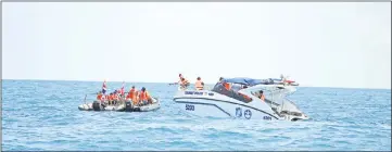  ??  ?? Rescuers search an area near Phuket.