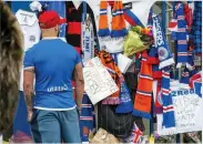  ??  ?? PAYING RESPECTS A fan outside Ibrox yesterday
