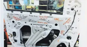  ?? SABRINA BYRNES OSHAWA THIS WEEK FILE PHOTO ?? Signatures from employees are seen inside the door frame of a 2019 GMC Sierra Double Cab, the last truck produced at the General Motors Oshawa plant last December.