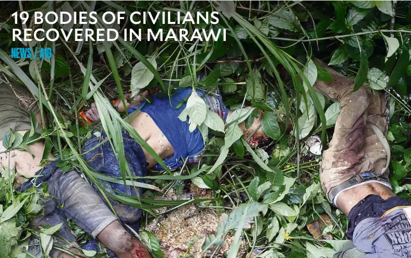  ?? —JEOFFREY MAITEM ?? CIVILIANS KILLED The bodies of eight laborers reportedly killed by terrorists who besieged Marawi City were thrown into a shallow ravine off the highway and found by soldiers.