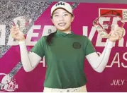 ??  ?? Taiwanese amateur Yu Chiang Hou lifts her two trophies, including the pro diadem after edging Thai Wanchana Poruangron­g on the second playoff hole.