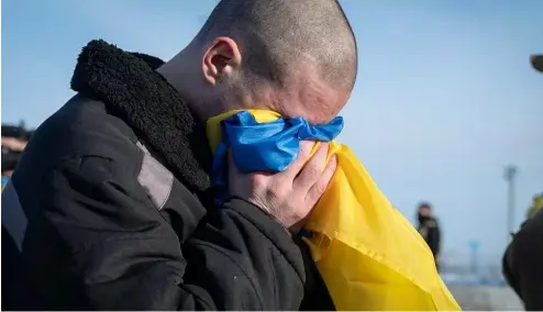  ?? ?? This photograph shared by Zelenskyy on X on Jan. 31, 2024, shows Ukrainian prisoners of war react after after a prisoner exchange at an undisclose­d location, Ukraine.
