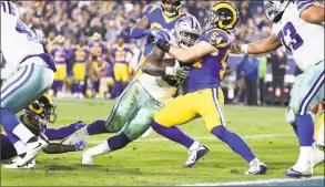  ?? Sean M. Haffey / Getty Images ?? The Rams’ Bryce Hager tackles Cowboys running back Ezekiel Elliott in the fourth quarter near the goal line in Los Angeles’ 30-22 victory on Saturday.