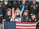  ?? JEFF PACHOUD/AFP ?? Mikaela Shiffrin, center, celebrates with teammates on the podium at the FIS Alpine Ski World Championsh­ip on Saturday in Meribel, French Alps.