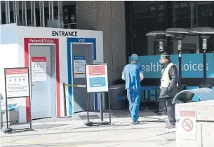  ?? RENÉ JOHNSTON TORONTO STAR ?? An attendant stands outside Mount Sinai Hospital. Hospitals are boosting capacity by cancelling elective surgeries as COVID-19 cases make up 31 per cent of all critical care patients in Ontario.