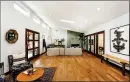  ??  ?? A polished concrete fireplace runs floor to ceiling in the indoor-outdoor living room.