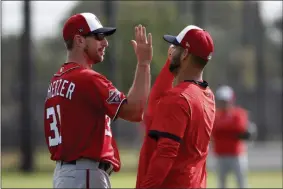  ?? JEFF ROBERSON ?? Washington Nationals pitcher Max Scherzer, left, gets a high-five from fellow pitcher Anibal Sanchez during spring training baseball practice Friday, Feb. 14, 2020, in West Palm Beach, Fla.