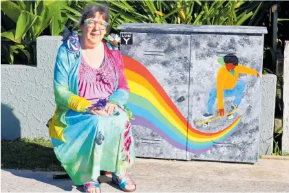  ?? Photo / Nikki Carroll ?? Arty Vicky and her fifth Chorus Cabinet Artwork mural, Skate the Rainbow, which represents the concept that doing something you love can turn a day from grey to bright.