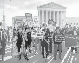  ?? DREW ANGERER/GETTY ?? Abortion rights and anti-abortion activists demonstrat­e Nov. 1 outside the Supreme Court as the justices hear arguments in a challenge to an abortion law.