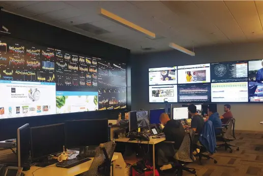  ?? (Nandita Bose/Reuters) ?? WALMART EMPLOYEES work at the company’s network operations center in Sunnyvale, California, last year. Facilities like this, which cost Walmart millions of dollars and took nearly five years to build, are starting to pay off. The retailer’s online...