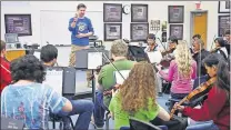  ?? ARCHIVES] [THE OKLAHOMAN ?? In a 2013 archive photo, former Edmond North High School Orchestra director Peter Markes works with students. The 2014 Oklahoma Teacher of the Year retired from the classroom in 2017 to pursue a career as a full-time musician.