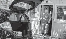  ?? Lauren Petracca/Associated Press ?? Jeremy Ward unloads groceries at his home in the Ridgeview Homes mobile home community in Lockport, N.Y. His rent has gone up three times since 2018.