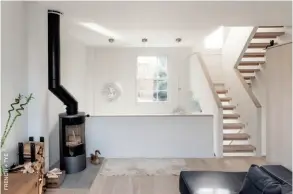  ??  ?? Above: As part of the renovation of this Victorian terraced house, the main reception room at the back of the property was removed to make way for a double height void above the kitchen-diner on the lower ground floor. The living room on the ground floor, pictured here, overlooks a new seating area in the basement level of the house. Above right: Situated on the lower ground floor of the property, the new seating area enjoys a direct connection to the rear garden. While puncturing the double height void through the heart of the property resulted in the loss of one room on the ground floor, the sense of overhead space creates one of the renovation’s most striking design features