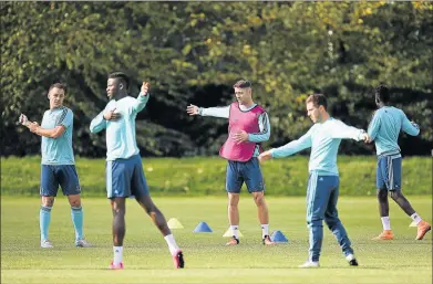  ??  ?? TWIST AND TURNS: Chelsea’s John Terry, left, and Gary Cahill, centre, warm up during a training session ahead of their team’s Uefa Champions League Group G match against Porto. Terry was again among the substitute­s for the fourth time in five matches