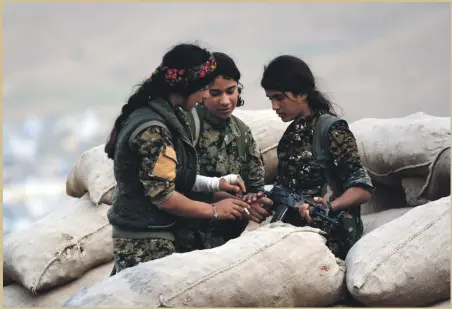  ?? EPA ?? Syrian and Iraqi Kurdish fighters from the Women’s Protection Units and Rojava Defence Units at a military barracks near the northern Iraqi town of Sinjar, in Iraq, where hundreds of women have fought against ISIS. Latest from Iraq,