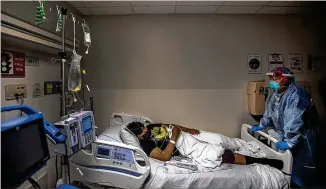  ?? FRANCINE ORR/LOS ANGELES TIMES ?? Dr. Anita Sircar talks last month with one of her COVID-19 patients, Angel Cordero, 19, at a hospital in Torrance, California. “It’s the worst experience ever,” he said.