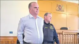  ?? ROSIE MULLALEY/THE TELEGRAM ?? Mark Rumboldt — who was found not guilty Saturday of attempted murder, but guilty of administer­ing a noxious substance to his wife — is led into Newfoundla­nd and Labrador Supreme Court in St. John’s Tuesday to have a date set for his sentencing hearing.