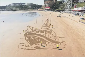  ??  ?? Message in the sand ... Monday’s artwork, made by RNLI volunteers alongside Sand in Your Eye artists, with the 349 denoting the number of lives saved nationally in 2020.