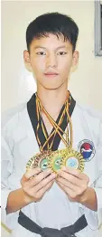  ??  ?? Sii displays his medal collection from the Sarawak Taekwondo (WTF) Championsh­ip which ended yesterday.