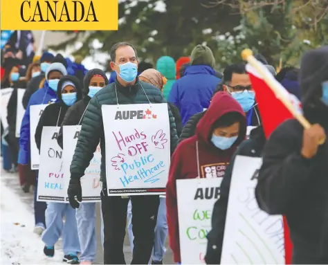  ?? GAVIN YOUNG / POSTMEDIA NEWS ?? Health-care workers angry over provincial job cuts in the health sector protest during a walkout at the Foothills Hospital in Calgary on Monday.