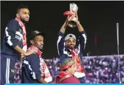  ??  ?? MUSCAT: Omani player Ahmed Mubarak holds the 23th Arabian Gulf Cup trophy during a celebratio­n ceremony for the team yesterday. — AFP