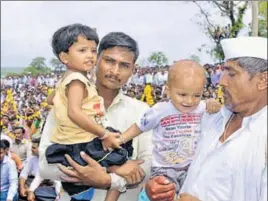  ?? HT PHOTO ?? Slain jawan Sandip Jadhav's father (in white) and two children attend his funeral at Kelgaon village in Aurangabad on Saturday. Jadhav, who was among the two soldiers killed in a crossborde­r ambush, was cremated on his son’s first birthday.