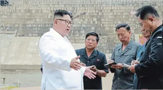  ?? THE ASSOCIATED PRESS FILE PHOTO ?? In this undated photo provided by the North Korean government, North Korean leader Kim Jong Un, left, inspects the constructi­on site of a hydroelect­ric power plant in North Hamgyong Province.