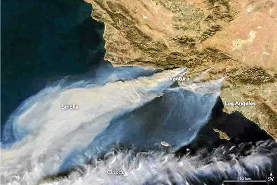  ?? PHOTO: AP ?? This natural colour image from Nasa’s Terra satellite shows plumes of smoke from Southern California wildfires being blown over the Pacific Ocean. The largest plume is from fires in Ventura County. The smaller plume at bottom is from fires in the Los...