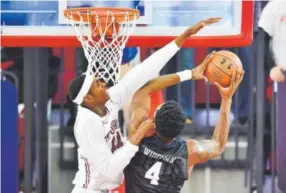  ??  ?? Butler's Tyler Wideman (4) has his shot blocked by St. John's Tariq Owens during a college basketball game in New York, Thursday, Dec. 29, 2016. Steven Ryan, Newsday