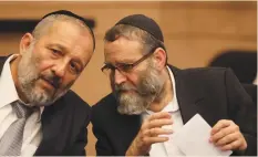  ?? (Ammar Awad/Reuters). ?? INTERIOR MINISTER Aryeh Deri, speaks to current deputy health minister Moshe Gafni at a Knesset meeting in September.