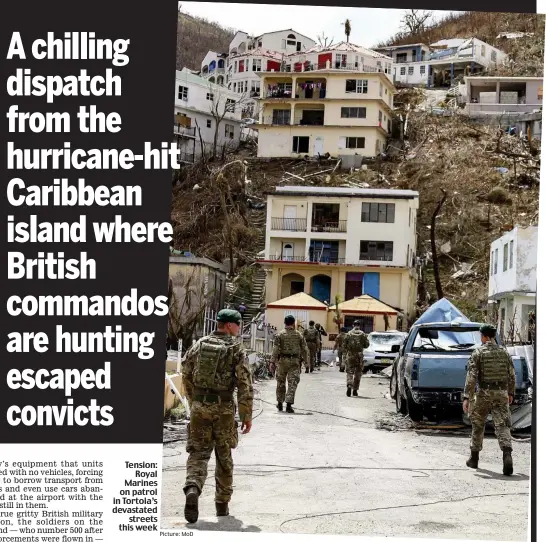  ?? Picture: MoD ?? Tension: Royal Marines on patrol in Tortola’s devastated streets this week