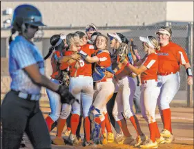  ?? L.E. Baskow Las Vegas Review-journal @Left_eye_images ?? Coronado players celebrate their second victory of the day, a 4-2 win over Shadow Ridge, which earned the Cougars a spot in next week’s Class 5A state tournament.